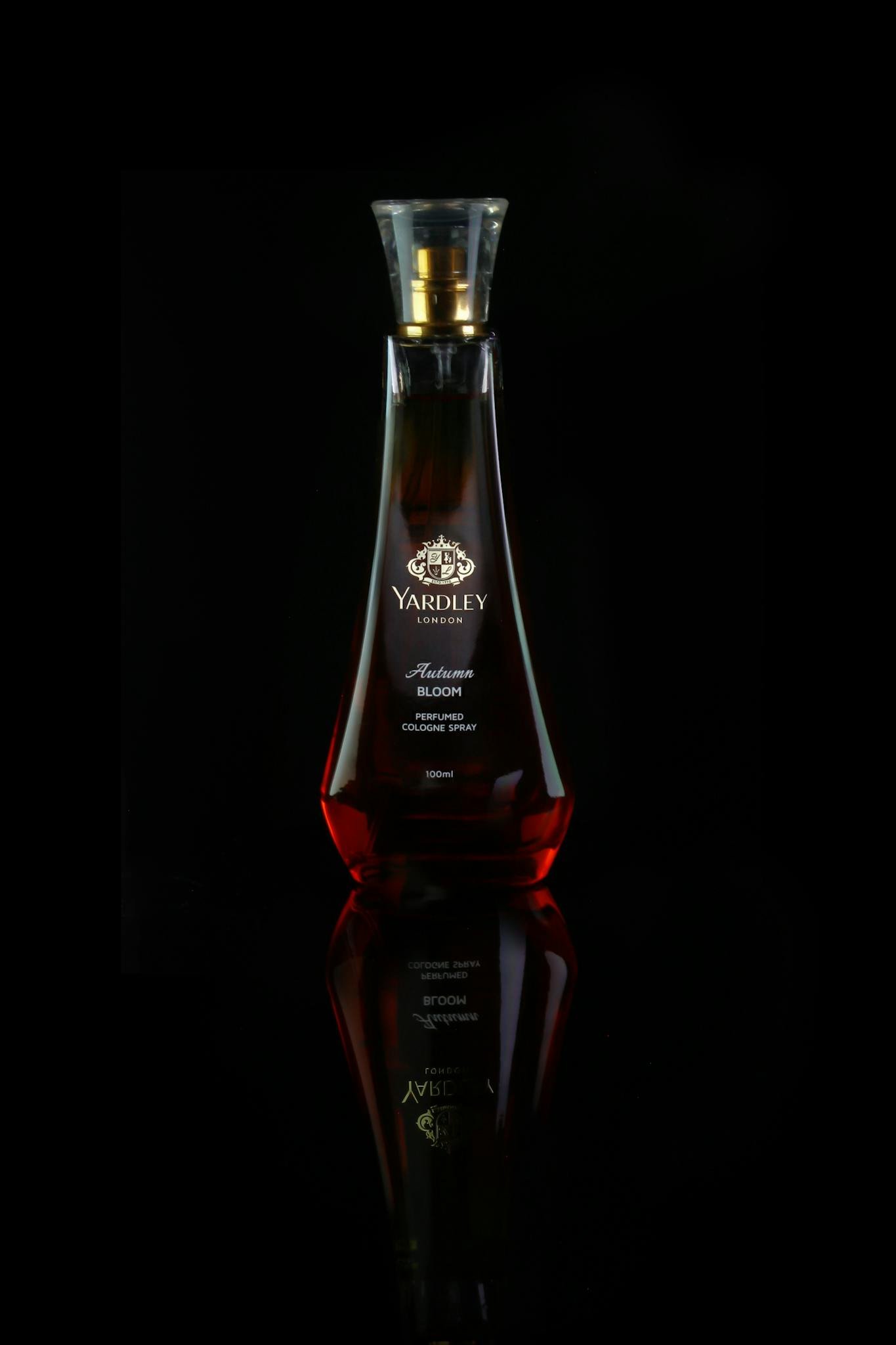 Stylish perfume bottle by Yardley on a dark reflective surface, showcasing luxury and allure.